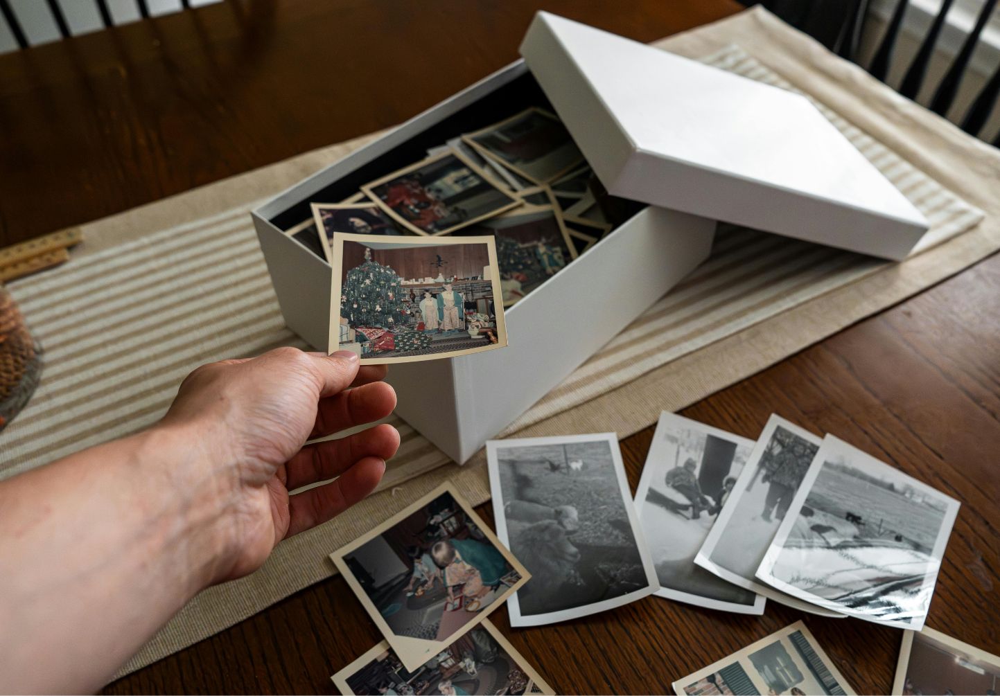 Someone looking through old family photos